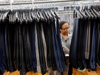 Imalay Lugo looks for the corresponding bottom for a custom suit at the Joseph Abboud manufacturing plant in New Bedford, MA.   [ PETER PEREIRA/THE STANDARD-TIMES/SCMG ]